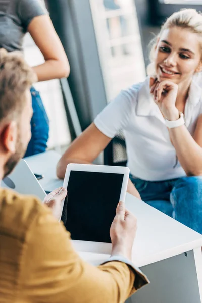 Cropped shot of young casual business people working with tablet together at office — Stock Photo