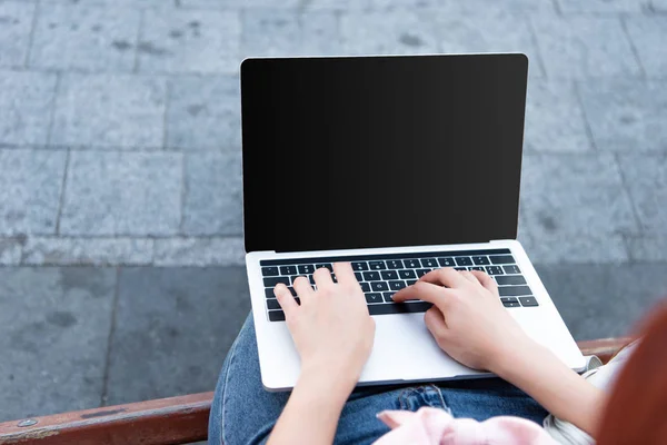 Cropped image of freelancer using laptop with lank screen on street — Stock Photo