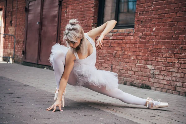 Beautiful young ballerina dancing on street — Stock Photo