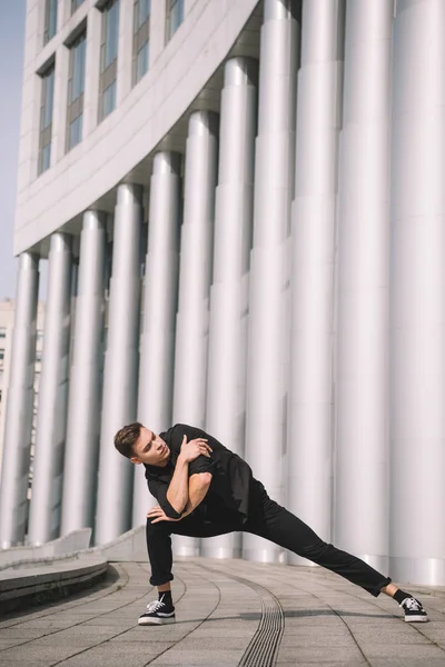 Handsome young man dancing on urban street — Stock Photo