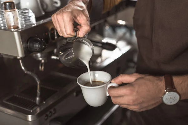 Tiro cortado de barista derramando leite em café enquanto o prepara no restaurante — Fotografia de Stock