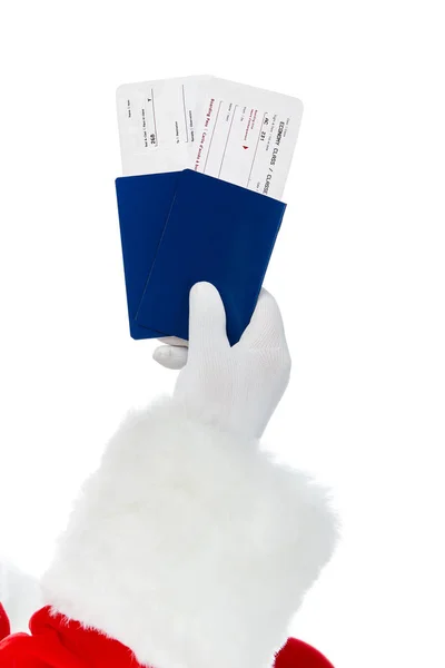 Cropped view of santa claus holding two passports and air tickets for christmas trip isolated on white — Stock Photo