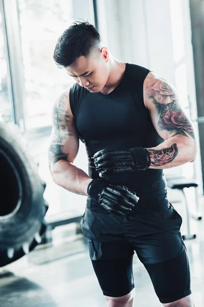 Young asian sportsman wearing boxing gloves — Stock Photo