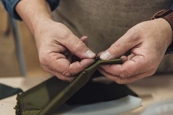 Cropped image of male handbag craftsman working at studio — Stock Photo