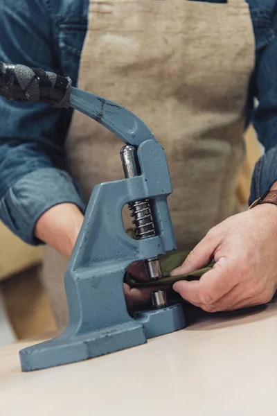 Cropped image of male handbag craftsman working with tool at studio — Stock Photo