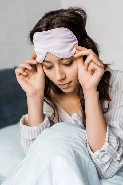 Attractive girl with sleeping eye mask on head — Stock Photo