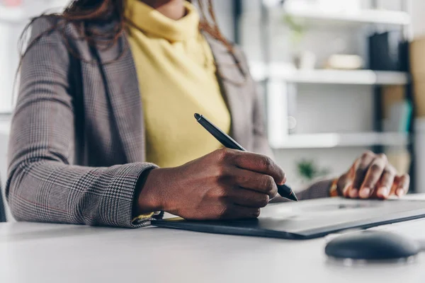 Section médiane du concepteur afro-américain en utilisant une tablette graphique au bureau moderne — Photo de stock