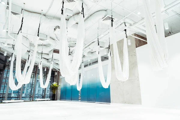 Light white spacious studio equipped for antigravity yoga — Stock Photo