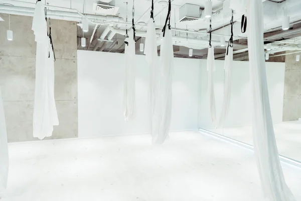 Light white spacious studio equipped for antigravity yoga — Stock Photo