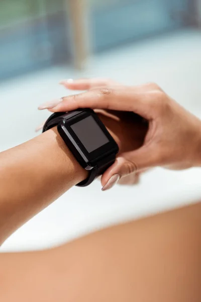 Partial view of girl using fitness tracker — Stock Photo