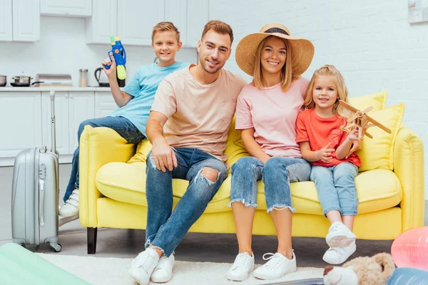 Famiglia che riposa sul divano dopo aver imballato per le vacanze estive, concetto di viaggio — Foto stock