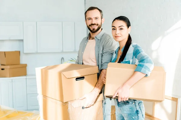 Marito e moglie che trasportano scatole di cartone e imballaggio per la nuova casa, concetto in movimento — Foto stock