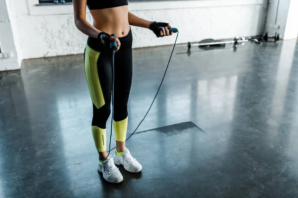 Cropped of sportswoman training with skipping rope at sports center — Stock Photo