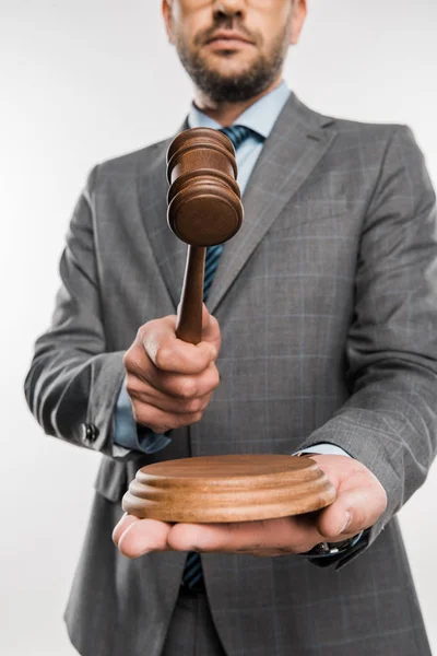 Cropped shot of judge holding wooden hammer isolated on white — Stock Photo