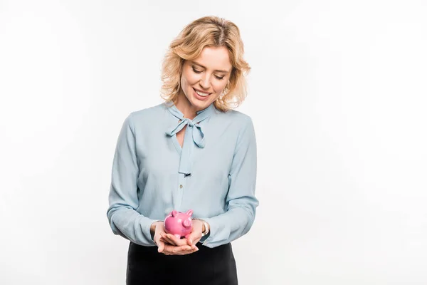 Happy businesswoman holding pink piggy bank isolated on white — Stock Photo