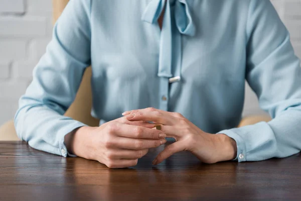 Mid section of woman taking off wedding ring, divorce concept — Stock Photo