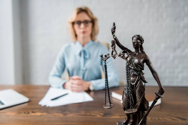 Close-up view of lady justice statue and female lawyer working behind — Stock Photo