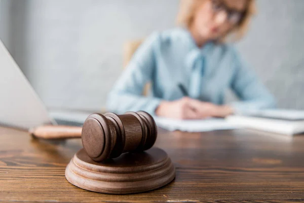 Close-up view of wooden hammer and female judge working behind — Stock Photo
