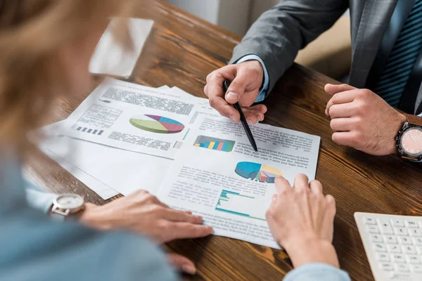 Visión parcial de los empresarios que trabajan con gráficos y gráficos en la oficina - foto de stock