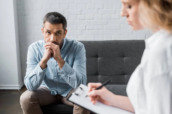 Sad adult man on psychologist therapy session at office — Stock Photo
