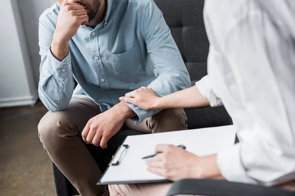 Cropped shot of depressed adult man on psychologist therapy session at office — Stock Photo