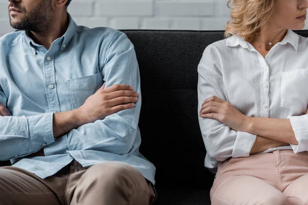 Cropped shot of couple sitting on couch after quarrel — Stock Photo