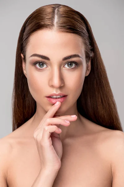 Portrait of beautiful pensive woman with brunette hair, isolated on grey — Stock Photo