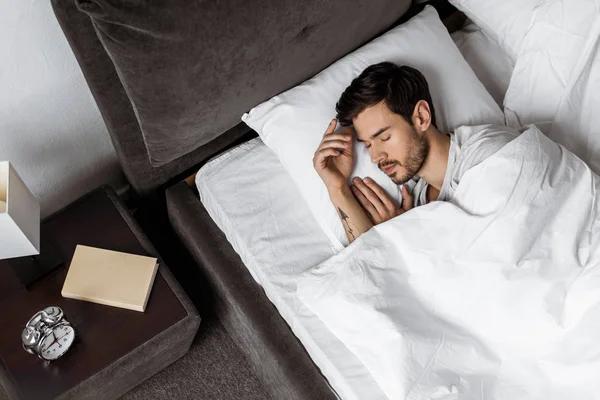 Top view of handsome bearded young man sleeping in bed in the morning — Stock Photo