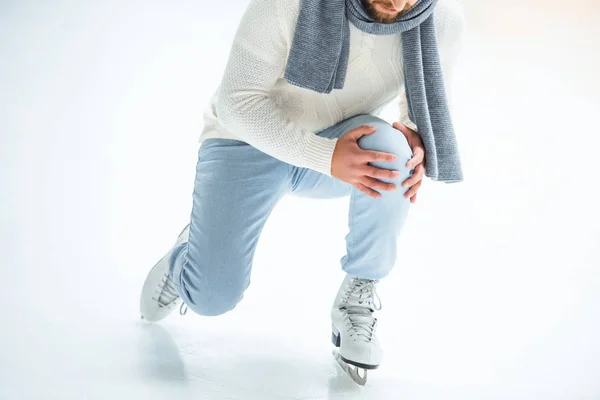 Cropped shot of man injured knee while skated on ice rink — Stock Photo