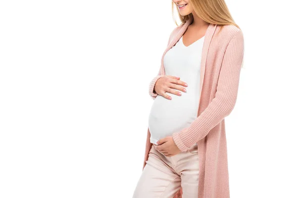 Счастливая, улыбающаяся беременная женщина касается живота обеими руками, изолированными на белом — стоковое фото