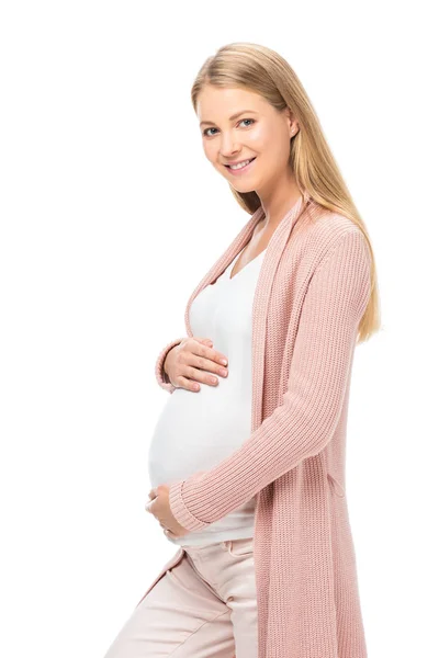 Mulher grávida tocando barriga, sorrindo e olhando para a câmera isolada no branco — Fotografia de Stock