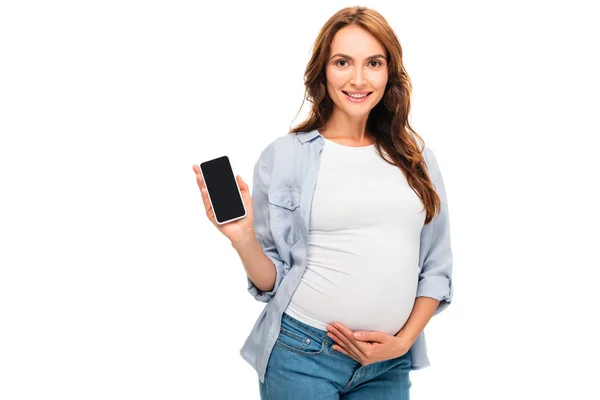 Mulher grávida segurando smartphone isolado no branco — Fotografia de Stock