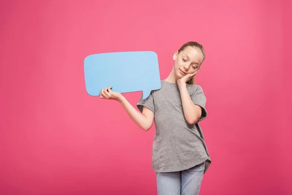 Tired youngster relaxing and holding blue speech bubble, isolated on pink — Stock Photo