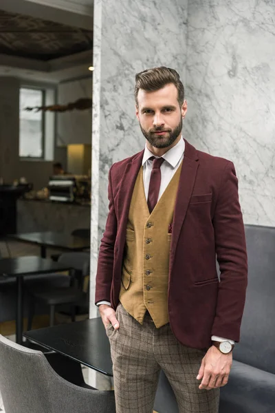 Confident businessman in formal wear with hand in pocket looking at camera — Stock Photo