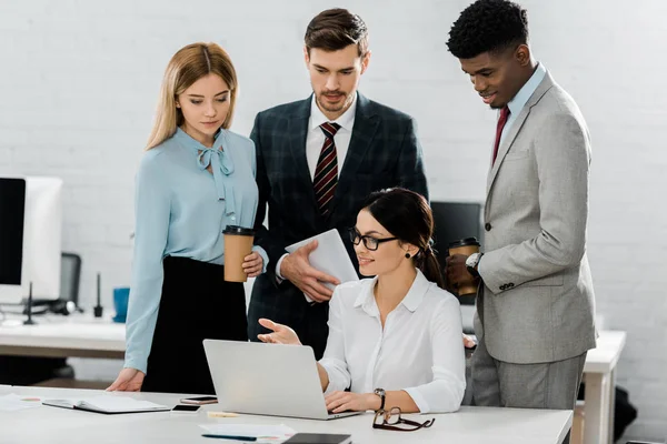 Multiethnic business colleagues in formal wear at workplace in office — Stock Photo