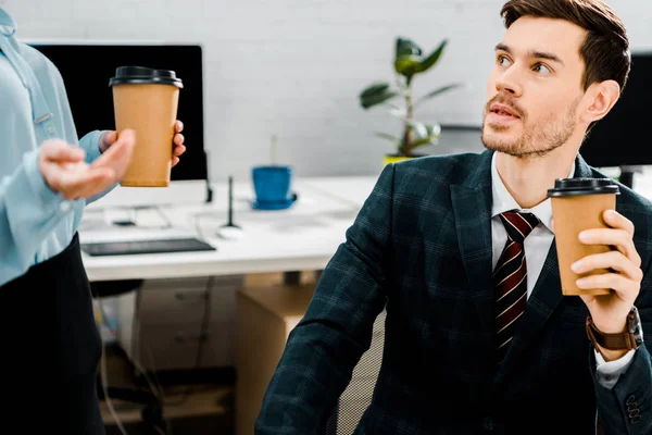 Partial view of business colleagues with coffee to go in office — Stock Photo