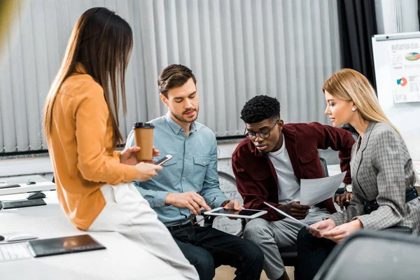 Multicultural young businesspeople discussing new business idea in office — Stock Photo