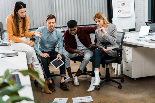 Multicultural young businesspeople discussing new business idea in office — Stock Photo