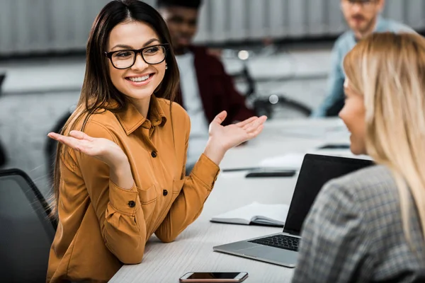 Selective focus of young businesswomen having conversation in office — Stock Photo