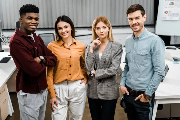 Portrait of young smiling multiracial business colleagues in office — Stock Photo