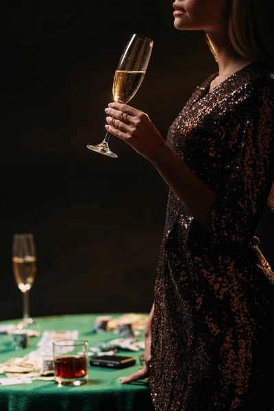 Cropped image of girl drinking champagne at casino — Stock Photo