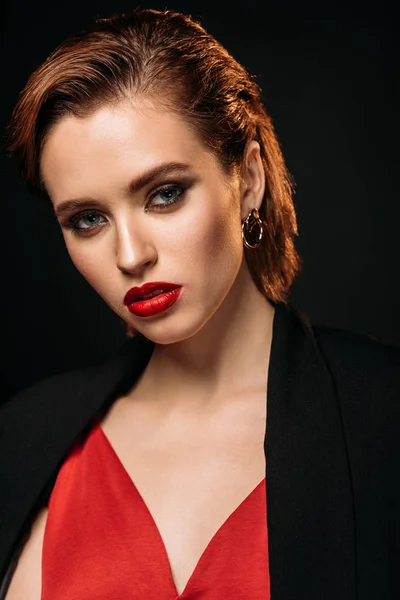 Portrait of attractive girl with makeup looking at camera isolated on black — Stock Photo