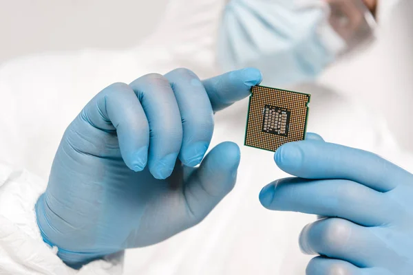 Selective focus of microprocessor in hands of scientist — Stock Photo