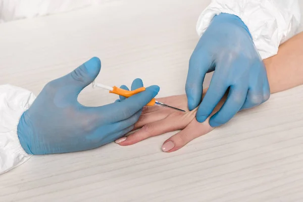 Cropped view of scientist making injection to woman — Stock Photo