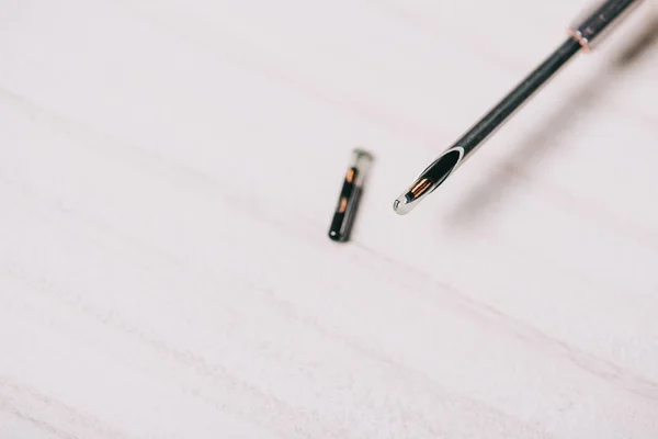 Close up of microchip and tool on grey table — Stock Photo