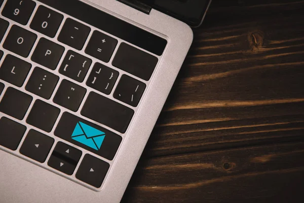 Close up top view of laptop keyboard with email icon on button — Stock Photo