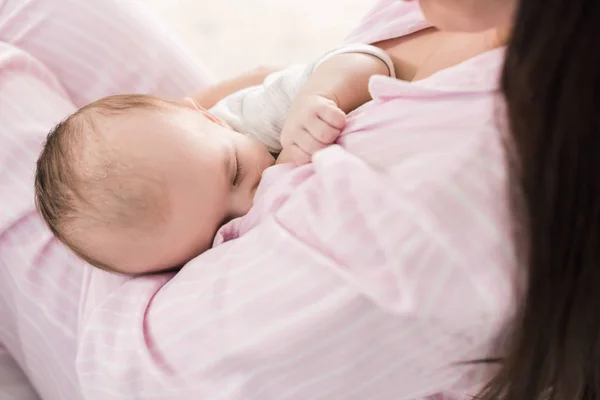 Partial view of mother breastfeeding little baby at home — Stock Photo