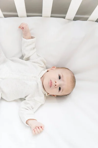 Overhead view of adorable baby in crib — Stock Photo