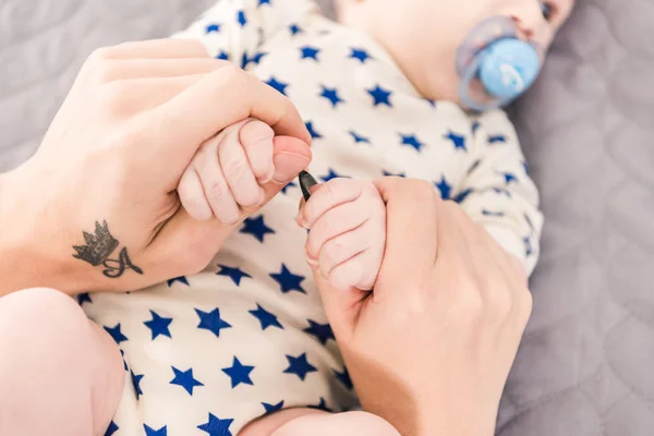 Partial view of father holding little babys hands — Stock Photo