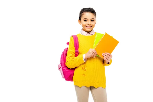 Adorable kid holding books and looking at camera isolated on white — Stock Photo